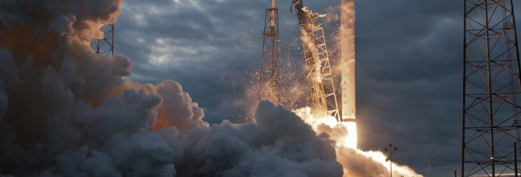 close up of space x rocket launch with cloud of smoke